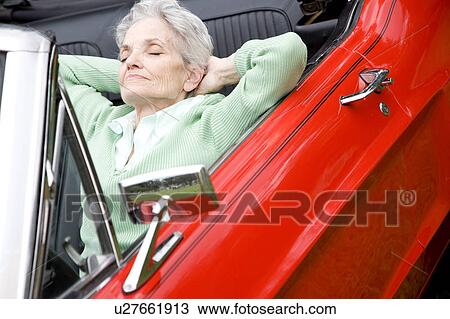 A senior woman sitting in a sports car View Large Photo Image Stock Image - A senior woman sitting in a sports car. Fotosearch
