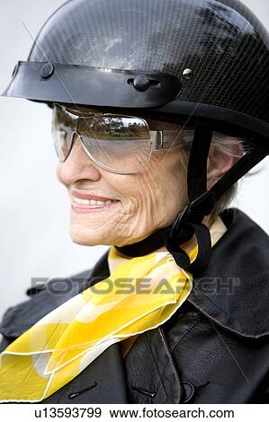 Stock Photo - A senior woman wearing a helmet. Fotosearch