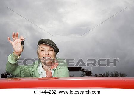 Portrait of a senior woman in a convertible car View Large Photo Image Stock Image - Portrait of a senior woman in a convertible car. Fotosearch