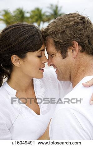A couple kissing on a beach View Large Photo Image Stock Image - A couple kissing on a beach. Fotosearch