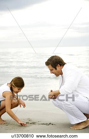A father and daughter on a beach View Large Photo Image Stock Image - A father and daughter on a beach. Fotosearch