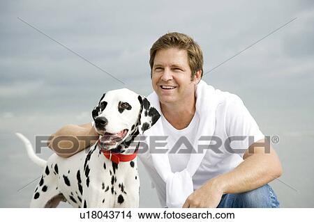 A man with his dog on a beach View Large Photo Image Picture - A man with his dog on a beach. Fotosearch
