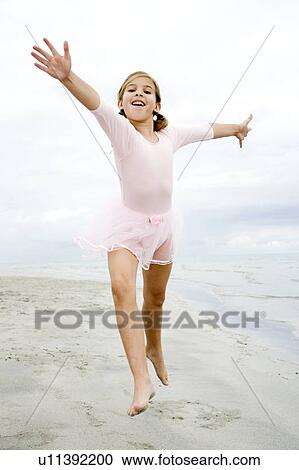 A young girl on a beach View Large Photo Image Stock Image - A young girl on a beach. Fotosearch