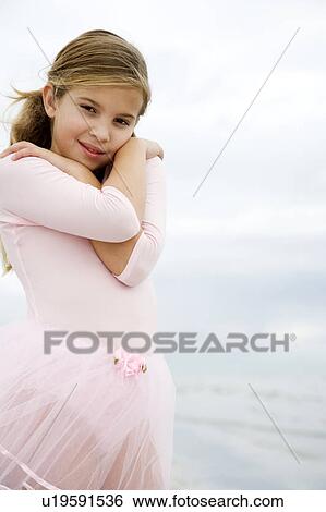 A young girl on a beach View Large Photo Image Stock Photograph - A young girl on a beach. Fotosearch