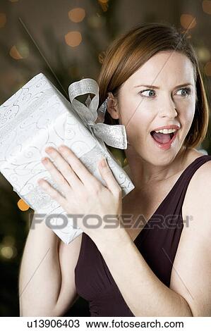 A woman holding a present View Large Photo Image Stock Image - A woman holding a present. Fotosearch
