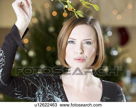 A woman waiting for kiss under the mistletoe View Large Photo Image Stock Image - A woman waiting for kiss under the mistletoe. Fotosearch