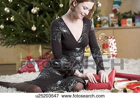 A woman wrapping Christmas presents View Large Photo Image Stock Photo - A woman wrapping Christmas presents. Fotosearch