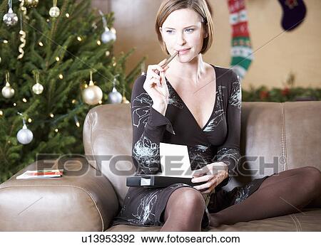 Stock Image - A woman writing Christmas cards. Fotosearch