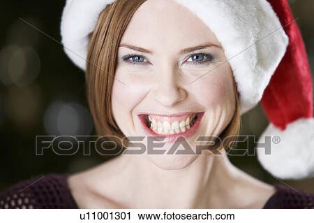 Portrait of a woman wearing Santa's hat View Large Photo Image Stock Image - Portrait of a woman wearing Santa's hat. Fotosearch