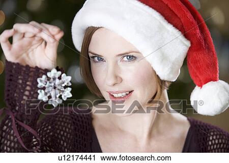Portrait of a woman wearing Santa's hat View Large Photo Image Stock Image - Portrait of a woman wearing Santa's hat. Fotosearch