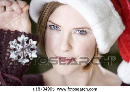 Portrait of a woman wearing Santa's hat View Large Photo Image Stock Photography - Portrait of a woman wearing Santa's hat. Fotosearch