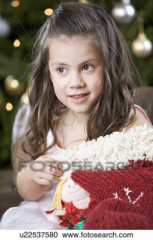 A young girl with a Christmas stocking View Large Photo Image Stock Image - A young girl with a Christmas stocking. Fotosearch