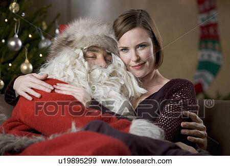 Father christmas / santa Claus and a woman relaxing View Large Photo Image Stock Photo - Father christmas / santa Claus and a woman relaxing. Fotosearch