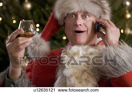 Father christmas / santa Claus relaxing after a hard days work View Large Photo Image Stock Image - Father christmas / santa Claus relaxing after a hard days work. Fotosearch