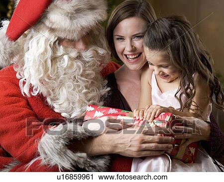 Father christmas / santa Claus with a mother and daughter View Large Photo Image Stock Image - Father christmas / santa Claus with a mother and daughter. Fotosearch
