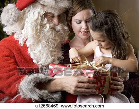 Father christmas / santa Claus with a mother and daughter View Large Photo Image Stock Photo - Father christmas / santa Claus with a mother and daughter. Fotosearch