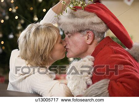 Stock Photo - Santa Claus kissing his wife. Fotosearch