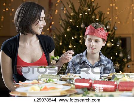A boy refusing to eat a Brussels sprout View Large Photo Image Picture - A boy refusing to eat a Brussels sprout. Fotosearch