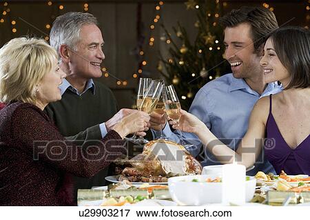 A family celebrating Christmas with a glass of champagne View Large Photo Image Stock Photo - A family celebrating Christmas with a glass of champagne. Fotosearch