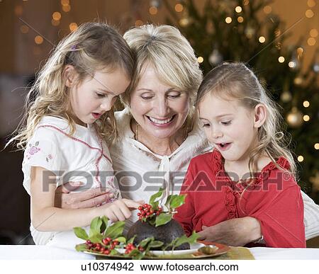 A grandmother and her granddaughters looking at a Christmas pudding View Large Photo Image Stock Image - A grandmother and her granddaughters looking at a Christmas pudding. Fotosearch