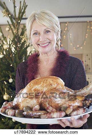 A grandmother with the Christmas turkey View Large Photo Image Stock Image - A grandmother with the Christmas turkey. Fotosearch