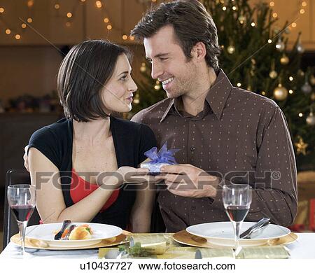 A husband and wife exchanging gifts View Large Photo Image Stock Photo - A husband and wife exchanging gifts. Fotosearch