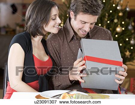 A husband and wife exchanging gifts View Large Photo Image Stock Photo - A husband and wife exchanging gifts. Fotosearch