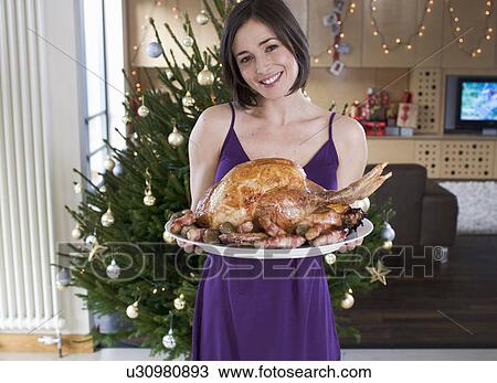 Stock Image - A mother with the Christmas turkey. Fotosearch