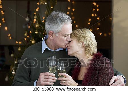 A senior couple drinking champagne View Large Photo Image Stock Photo - A senior couple drinking champagne. Fotosearch