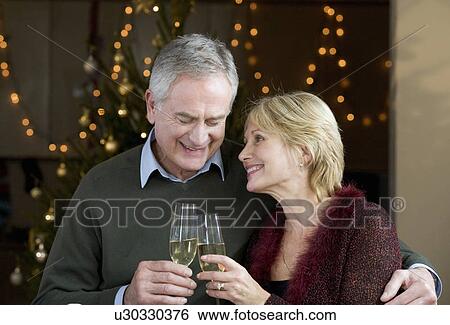 A senior couple drinking champagne View Large Photo Image Stock Photograph - A senior couple drinking champagne. Fotosearch