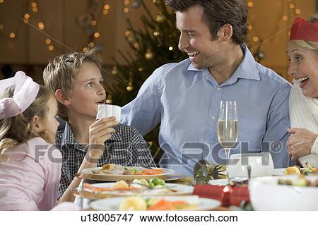 Family reading Christmas Cracker Jokes View Large Photo Image Stock Photo - Family reading Christmas Cracker Jokes. Fotosearch