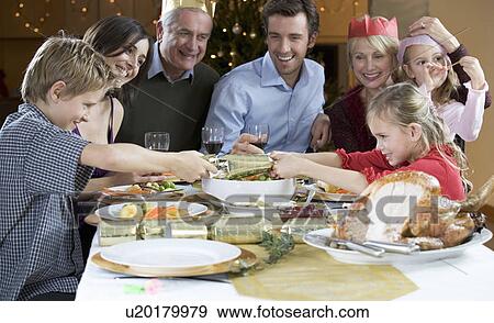 Pulling Christmas crackers View Large Photo Image Stock Photo - Pulling Christmas crackers. Fotosearch