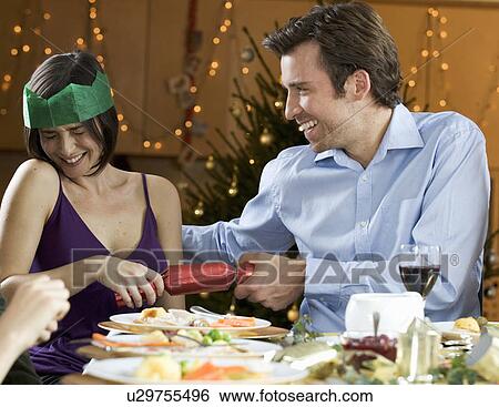 Pulling Christmas crackers View Large Photo Image Stock Photograph - Pulling Christmas crackers. Fotosearch