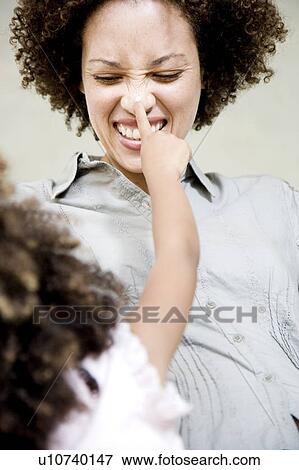 Little girl touching her mother's nose View Large Photo Image Stock Photo - Little girl touching her mother's nose. Fotosearch