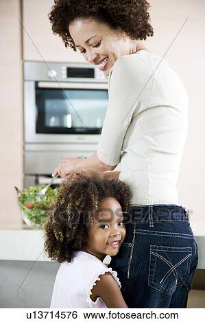 Mother and young daughter preparing healthy salad lunch together View Large Photo Image Stock Photograph - Mother and young daughter preparing healthy salad lunch together. Fotosearch
