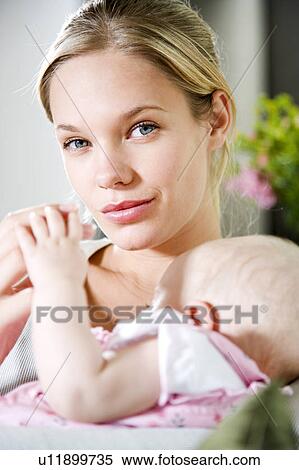 Mother sitting with baby girl View Large Photo Image Stock Photography - Mother sitting with baby girl. Fotosearch