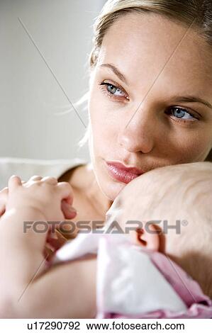 Mother with baby girl holding her finger View Large Photo Image Stock Image - Mother with baby girl holding her finger. Fotosearch