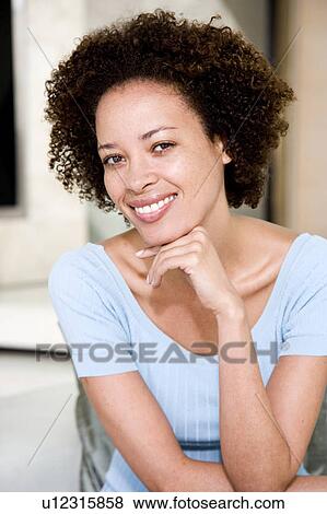 Portrait of a young woman, smiling View Large Photo Image Stock Photo - Portrait of a young woman, smiling. Fotosearch