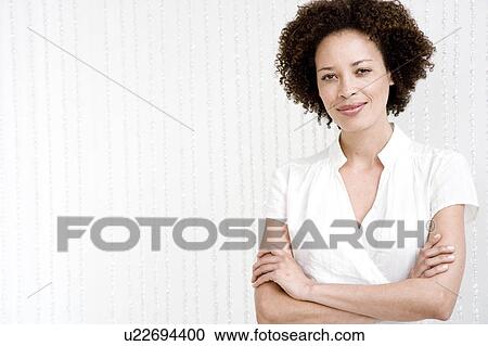 Portrait of confident woman in a white wraparound top View Large Photo Image Stock Image - Portrait of confident woman in a white wraparound top. Fotosearch