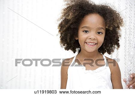 Stock Image - Portrait of happy little girl smiling. Fotosearch