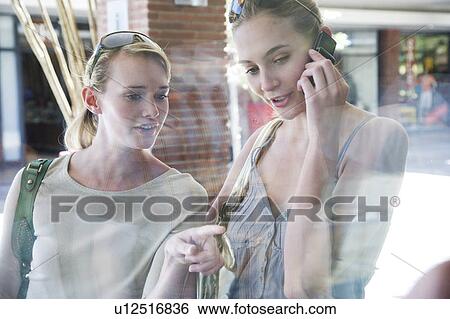 Stock Photograph - Two women window shopping. Fotosearch