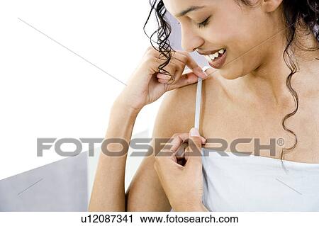Woman trying on a sun top in the changing room of a shop, adjusting the strap View Large Photo Image Stock Image - Woman trying on a sun top in the changing room of a shop, adjusting the strap. Fotosearch