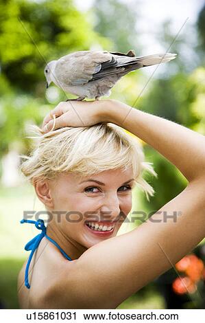 Beauty portrait of a woman in a tropical setting with a dove on her head. View Large Photo Image Stock Image - Beauty portrait of a woman in a tropical setting with a dove on her head.. Fotosearch