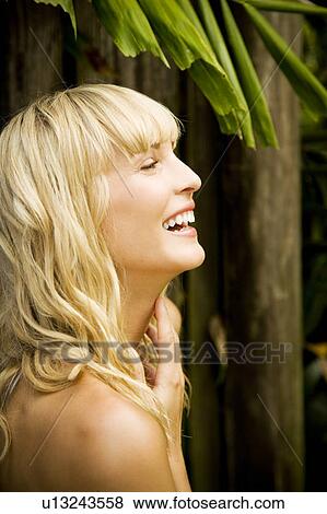 Stock Photo - Beauty portrait of a woman in a tropical setting.. Fotosearch