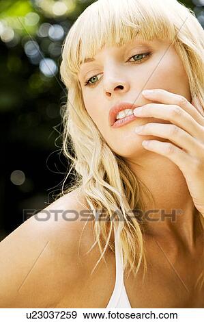 Beauty portrait of a woman in a tropical setting, hand touching her face. View Large Photo Image Stock Photo - Beauty portrait of a woman in a tropical setting, hand touching her face.. Fotosearch