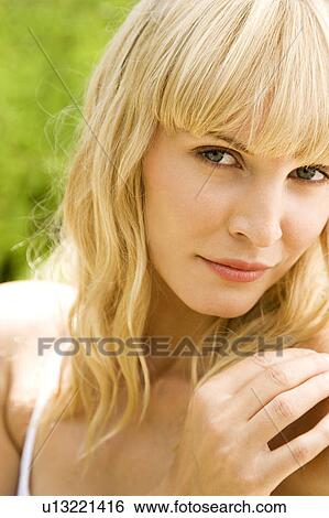 Stock Photograph - Beauty portrait of a woman in a tropical setting.. Fotosearch