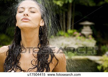 Stock Photography - Beauty portrait of a woman in a tropical shower setting.. Fotosearch