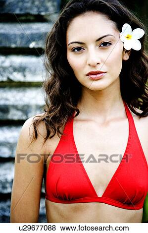 Beauty portrait of a woman in an oriental garden with frangipani in her hair View Large Photo Image Stock Photo - Beauty portrait of a woman in an oriental garden with frangipani in her hair. Fotosearch