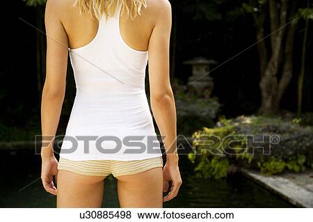 Rear view of a woman in a tropical setting. View Large Photo Image Stock Photo - Rear view of a woman in a tropical setting.. Fotosearch