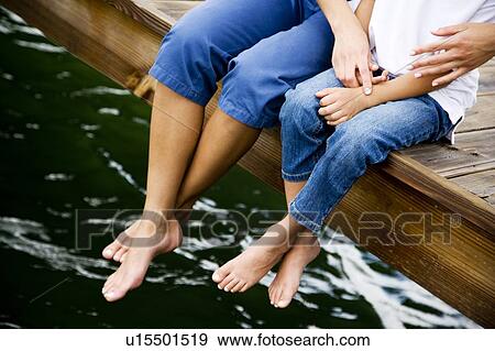 cropped image of woman and child sitting on jetty View Large Photo Image Stock Photo - cropped image of woman and child sitting on jetty. Fotosearch